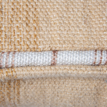 detail of neutral colored handwoven lumbar wool cushion