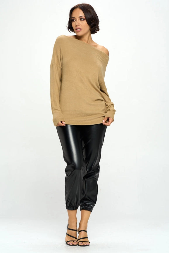 woman wearing khaki colored off shoulder top on black pants