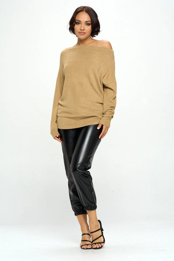 woman wearing khaki colored off shoulder top on black pants