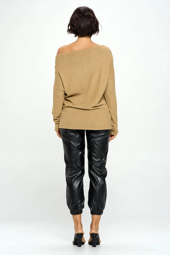 woman wearing khaki colored off shoulder top on black pants