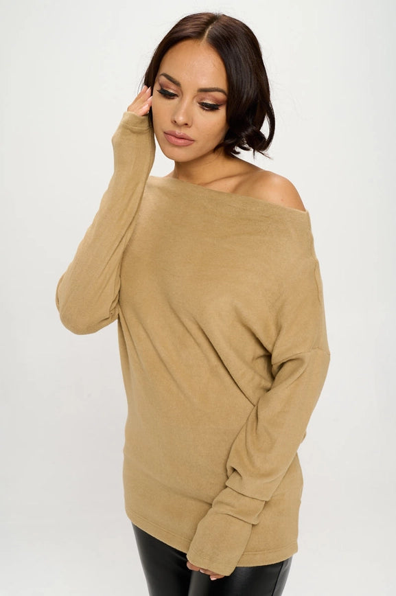 woman wearing khaki colored off shoulder top on black pants