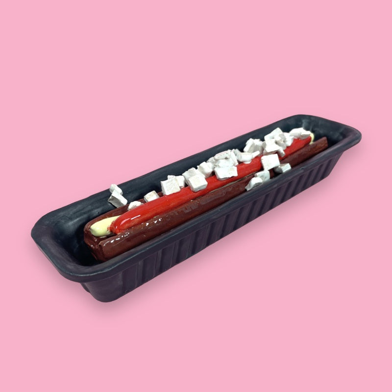 ceramic replica of Dutch snack frikandel speciaal in black open container