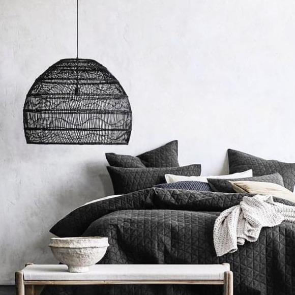 Bedroom with large black handwoven basket pendant light