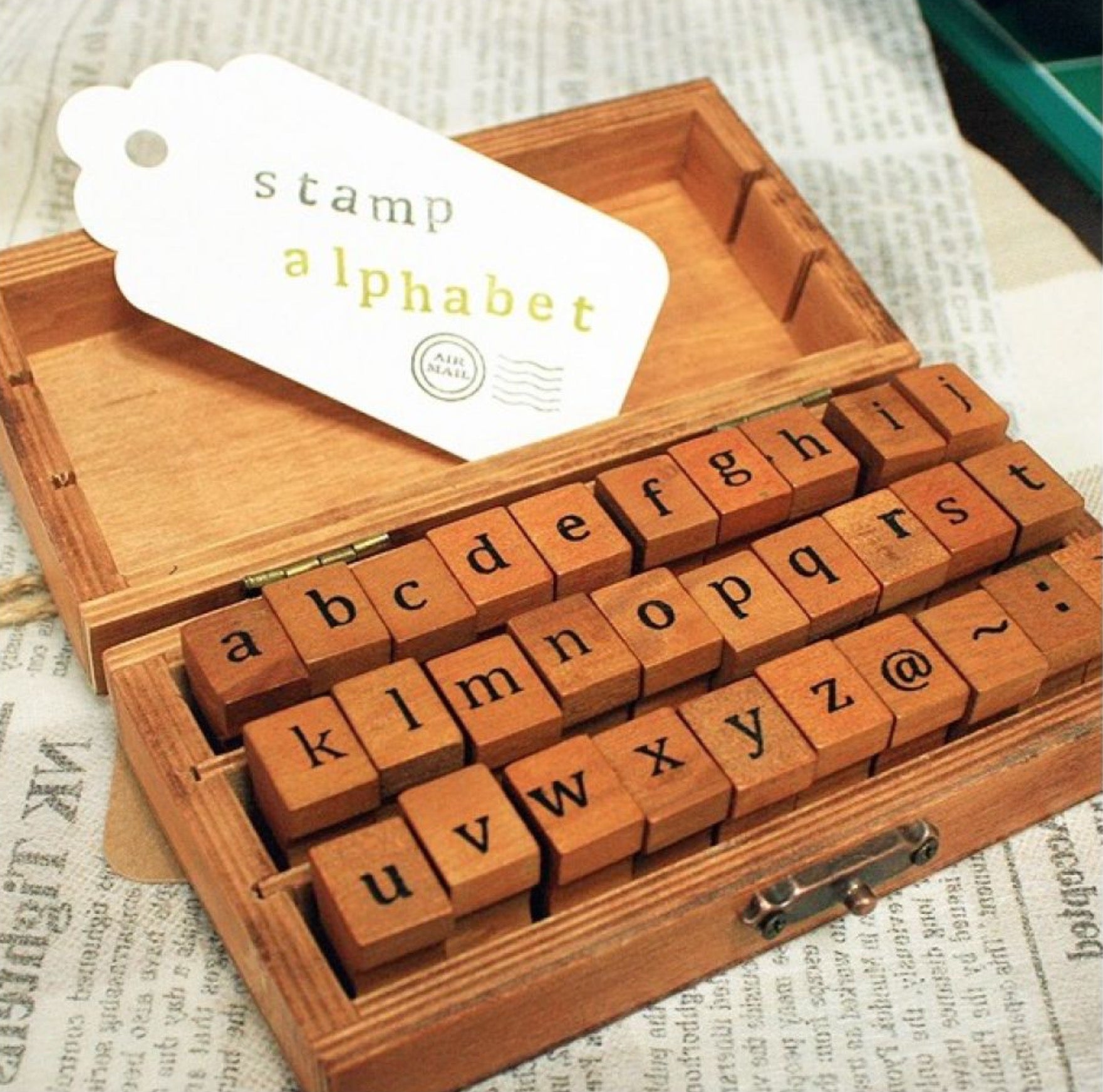 Wooden box with lowercase alphabet stamps