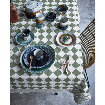 table setting with 1970's inspired ceramics in green, blue and black