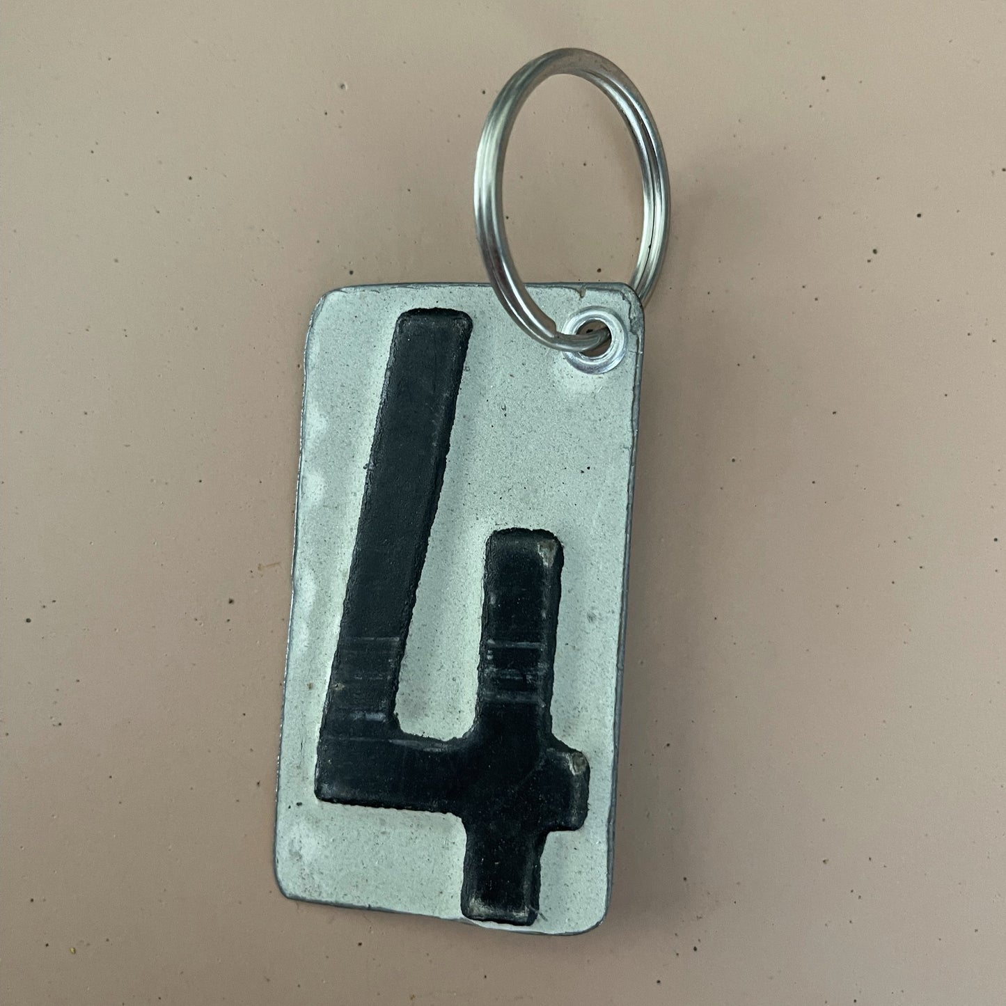 black number  4 keychain from recycled license plate