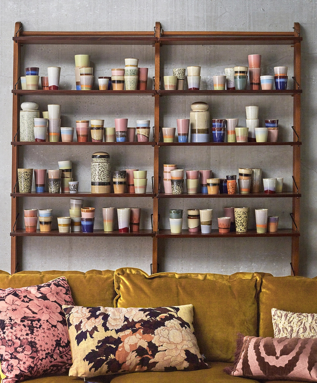 stoneware storage jar with reactive glaze in white with blue, greenish speckles in ceraics collection on display in an open shelving cabinet