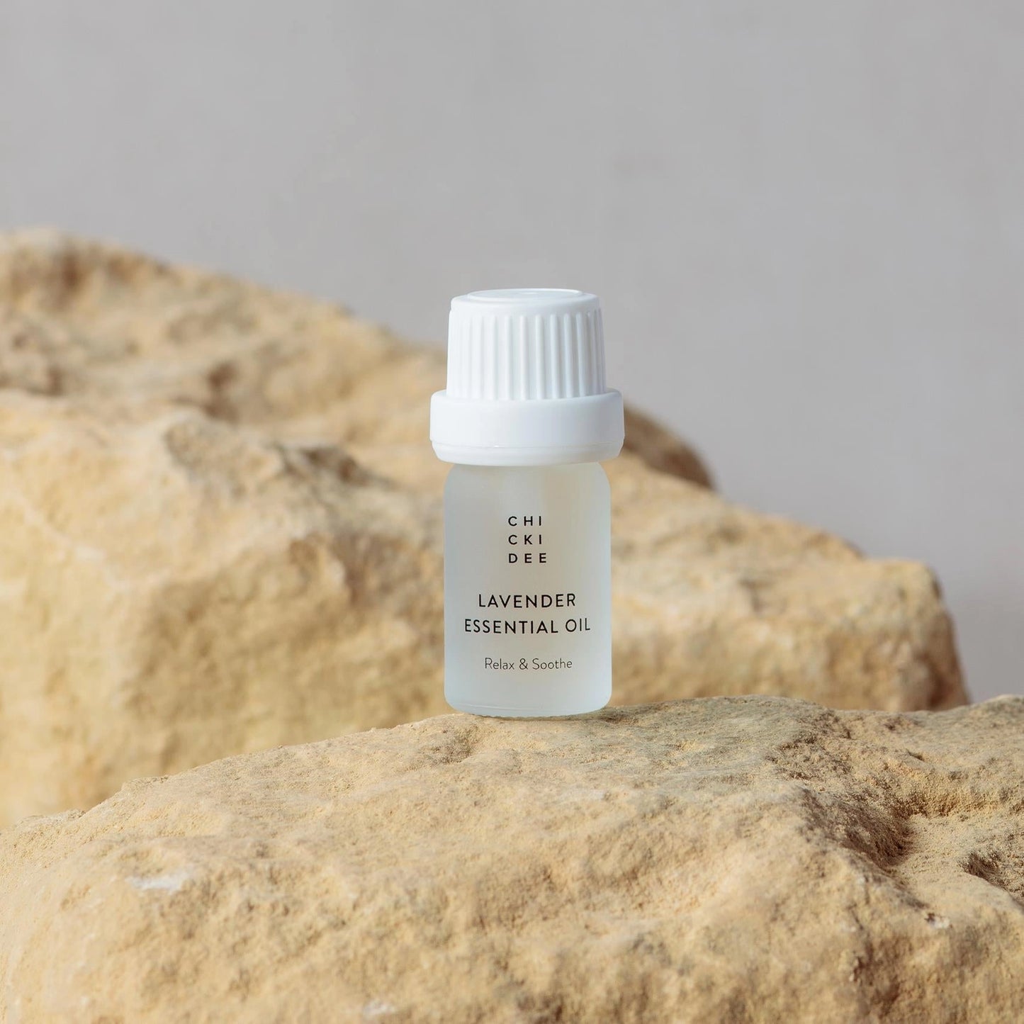 5ml glass bottle with essential lavender oil on a rock