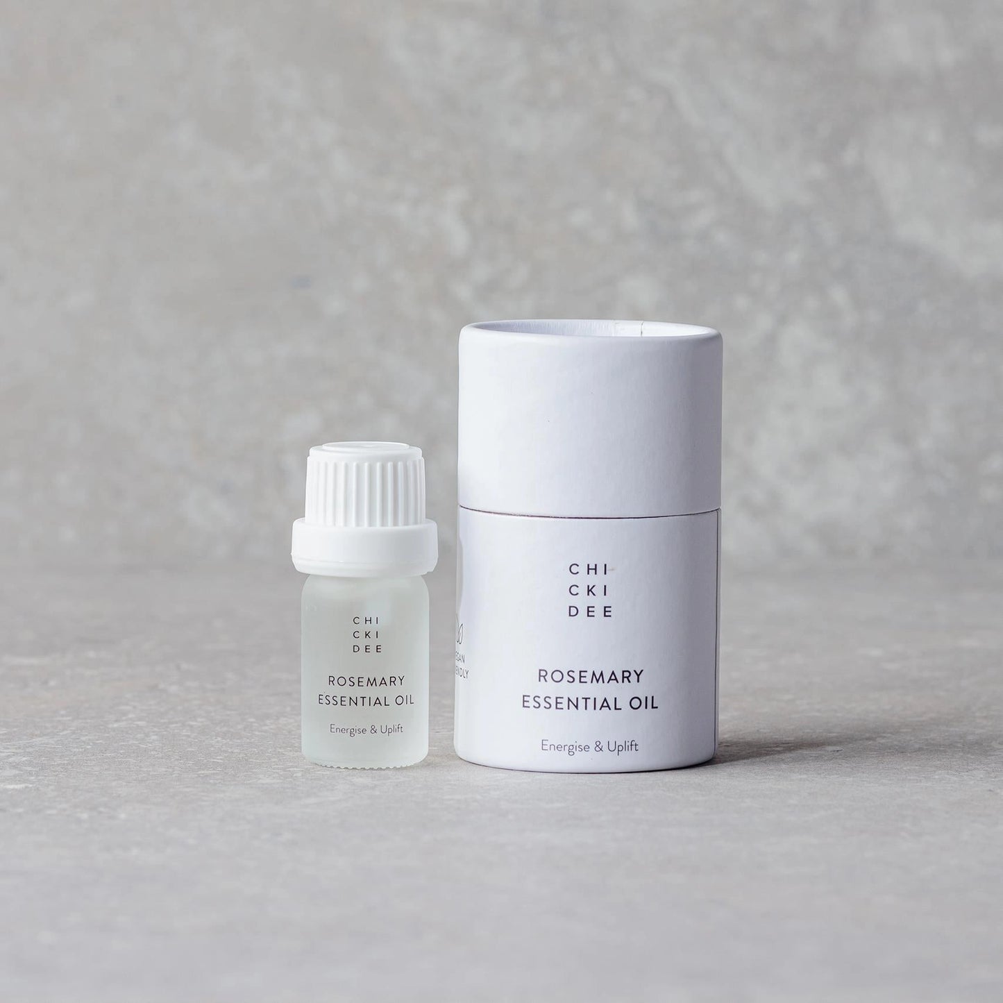 small glass bottle with essential rosemary oil and white box