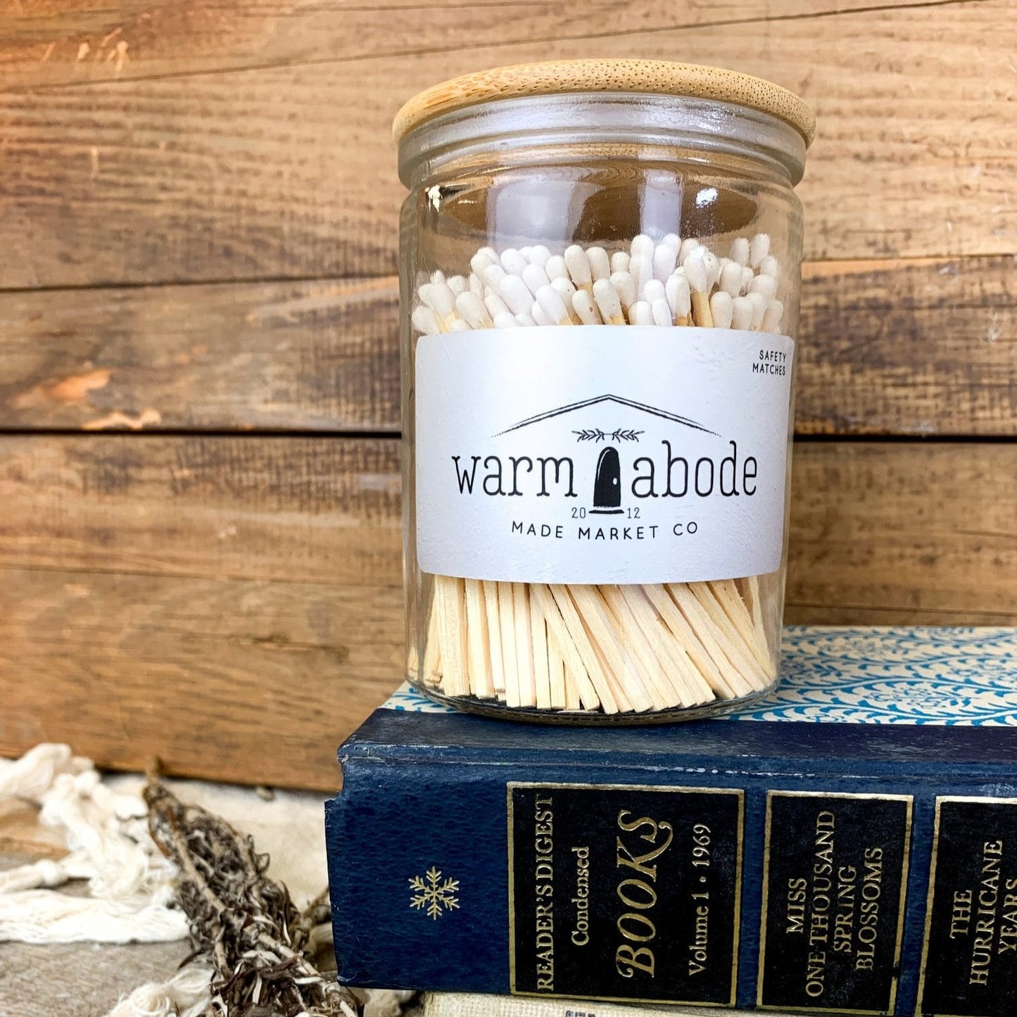 matches with white top in glass vessel with lid on a blue book