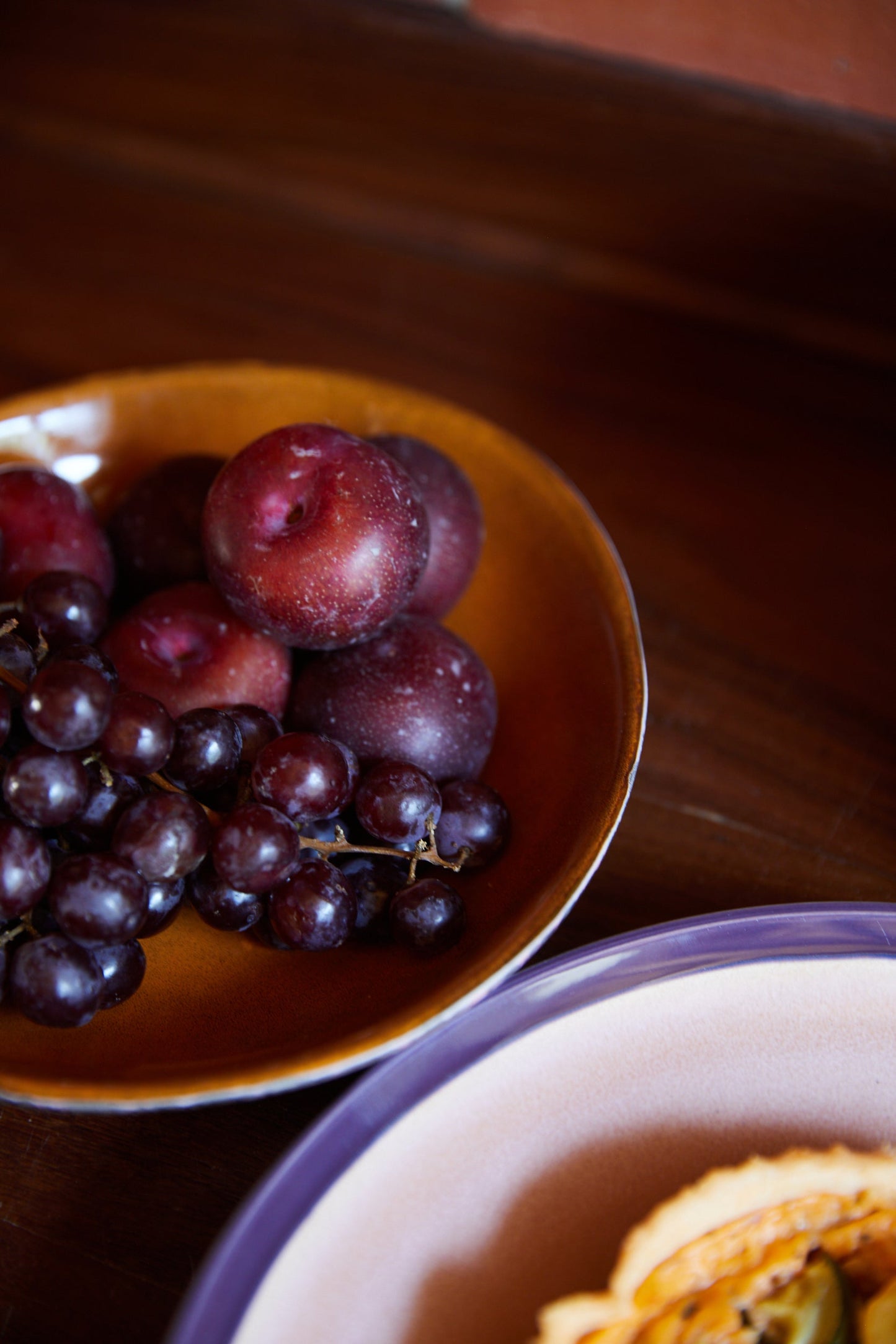 retro style deep plates with burnt orange inside and purple tones outside reactive glaze