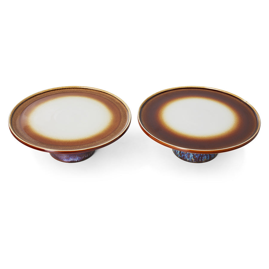 two retro style cake stands in brown hues with variations in finish