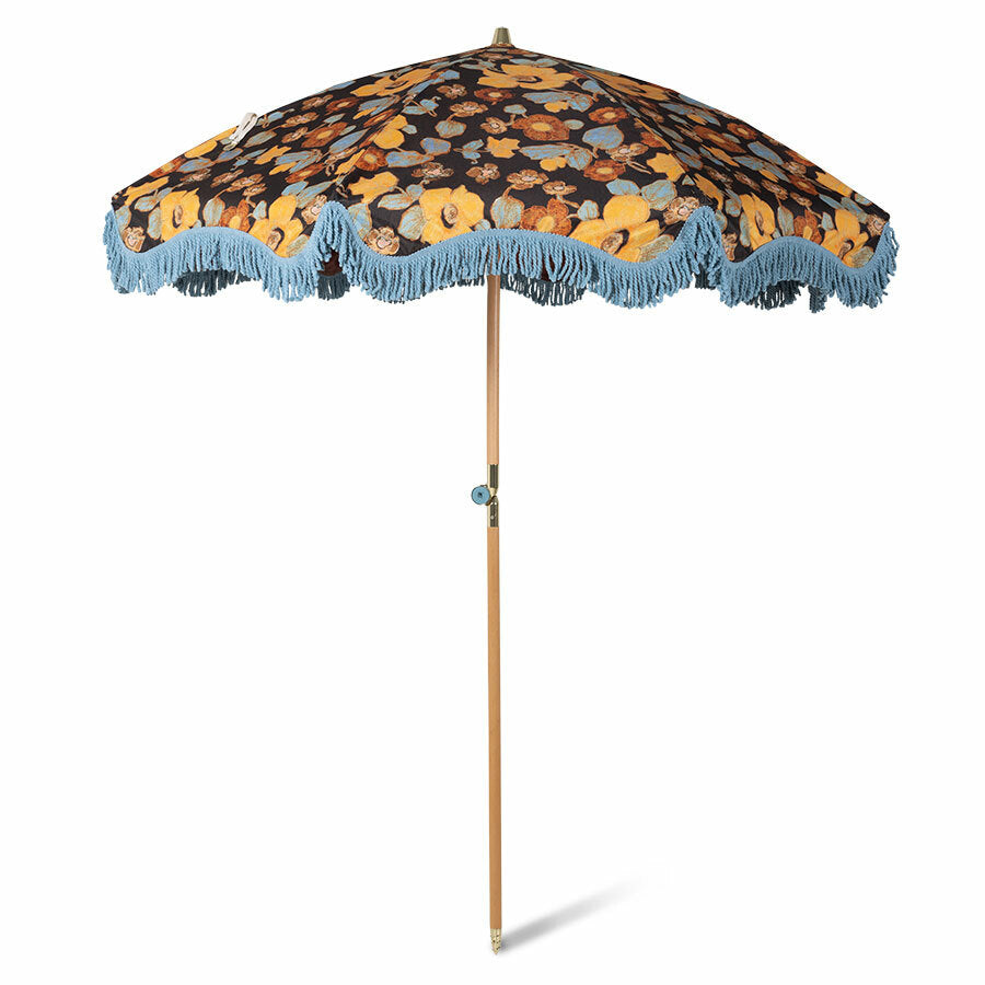 vintage style beach umbrella with floral fabric and blue fringes
