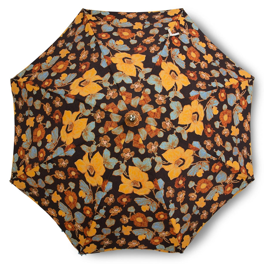 vintage style beach umbrella with floral fabric and blue fringes