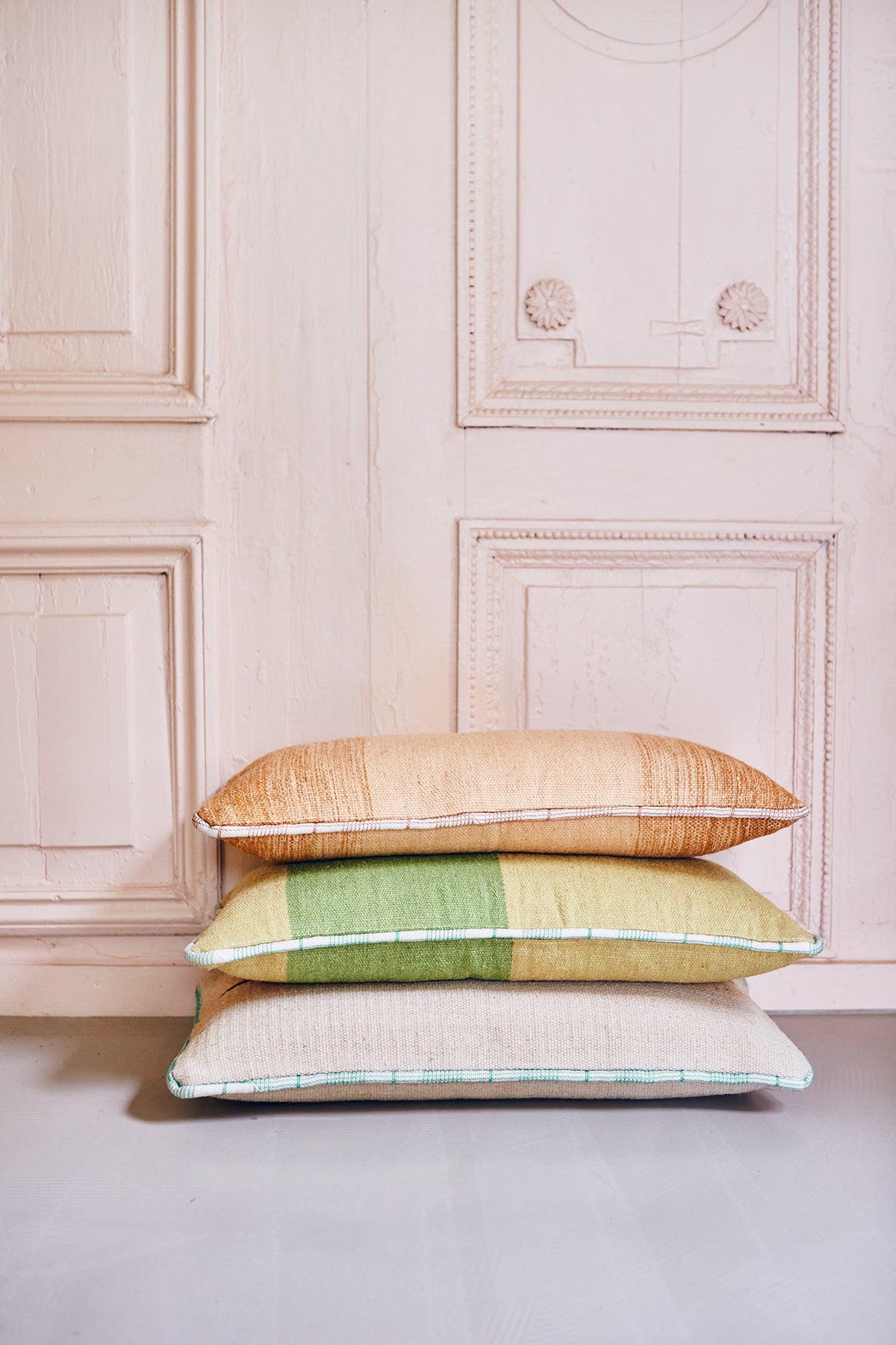 stack of 3 handwoven lumbar shaped woolen cushions