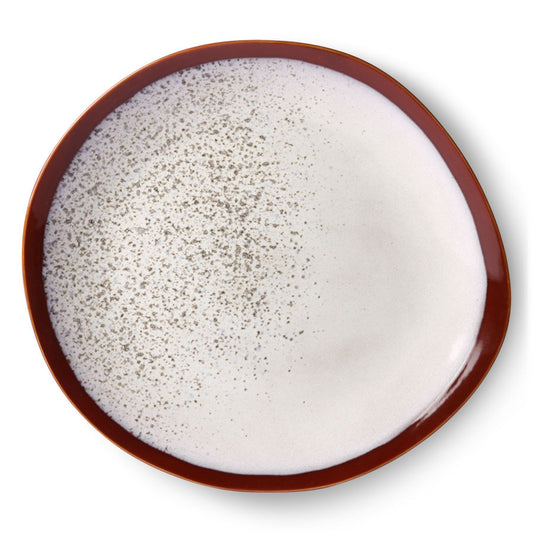 organic shape dinner plate with snow like pattern and brown red trim