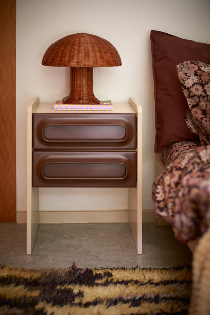 brown rattan retro style mushroom lamp on nightstand with brown drawers