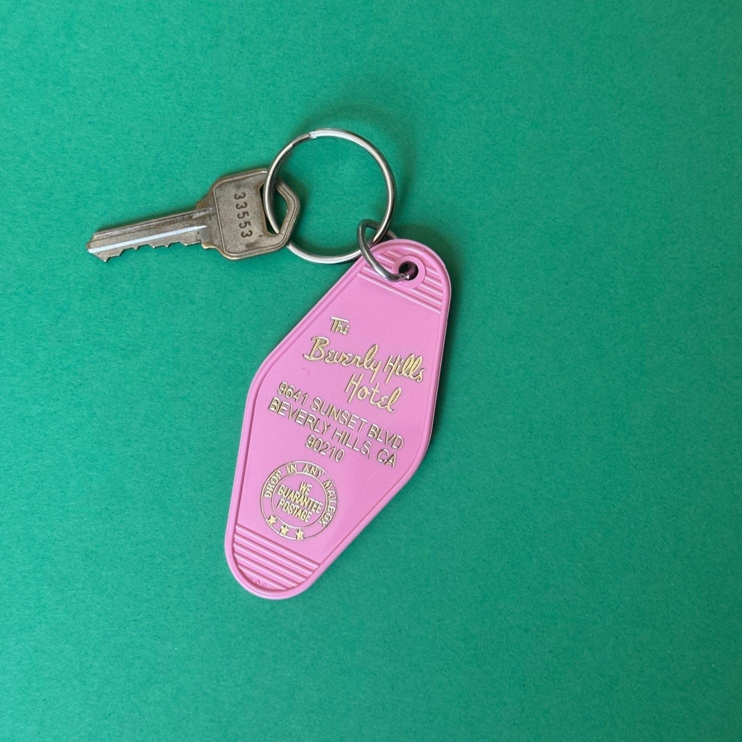 pink key fob with gold letters and key