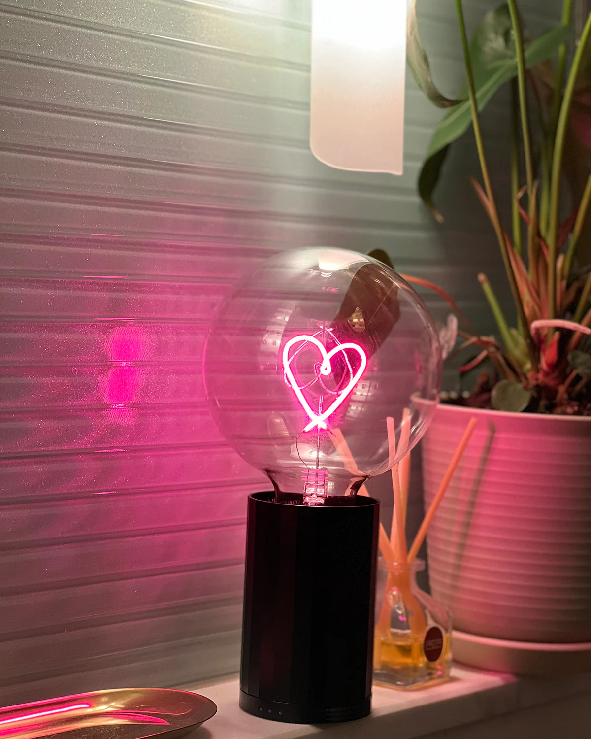 portable black aluminum base with large lightbulb with red heart