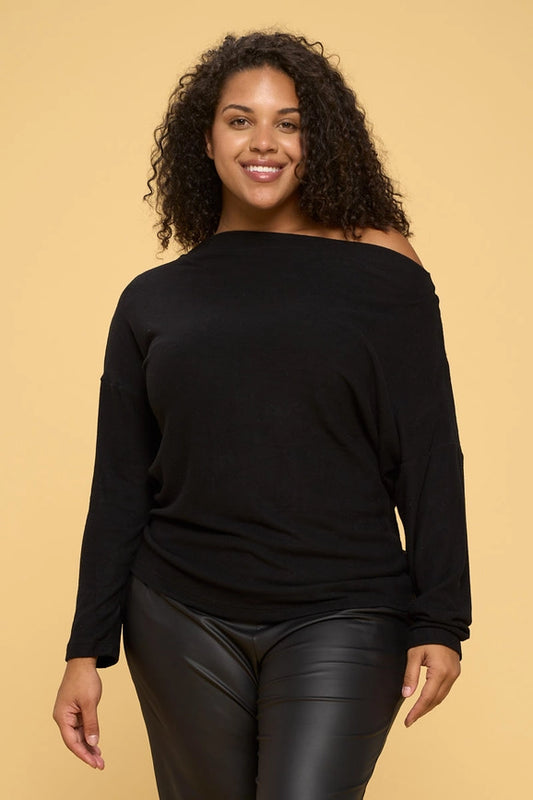 woman wearing black brushed knit off shoulder sweaters on black pants