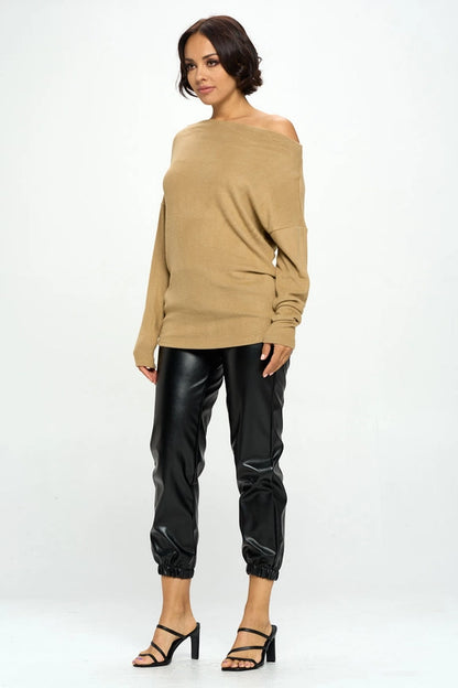 woman wearing khaki colored off shoulder top on black pants