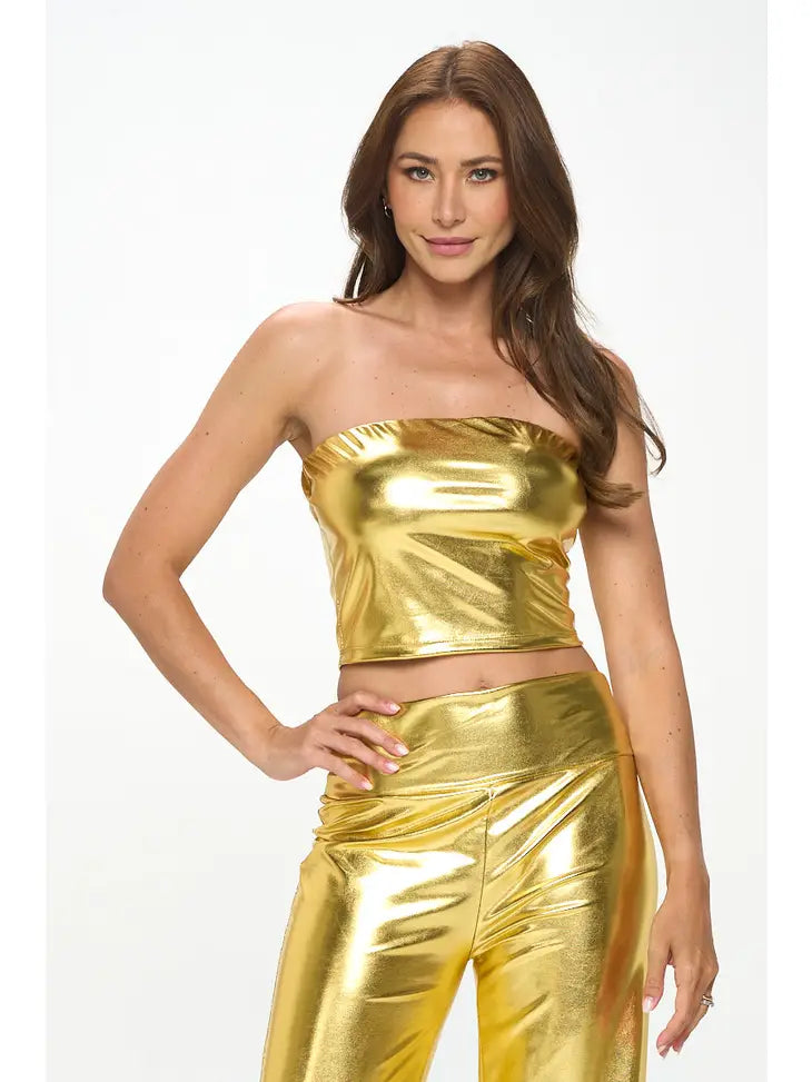 woman wearing a gold colored tub crop top and gold colored pants