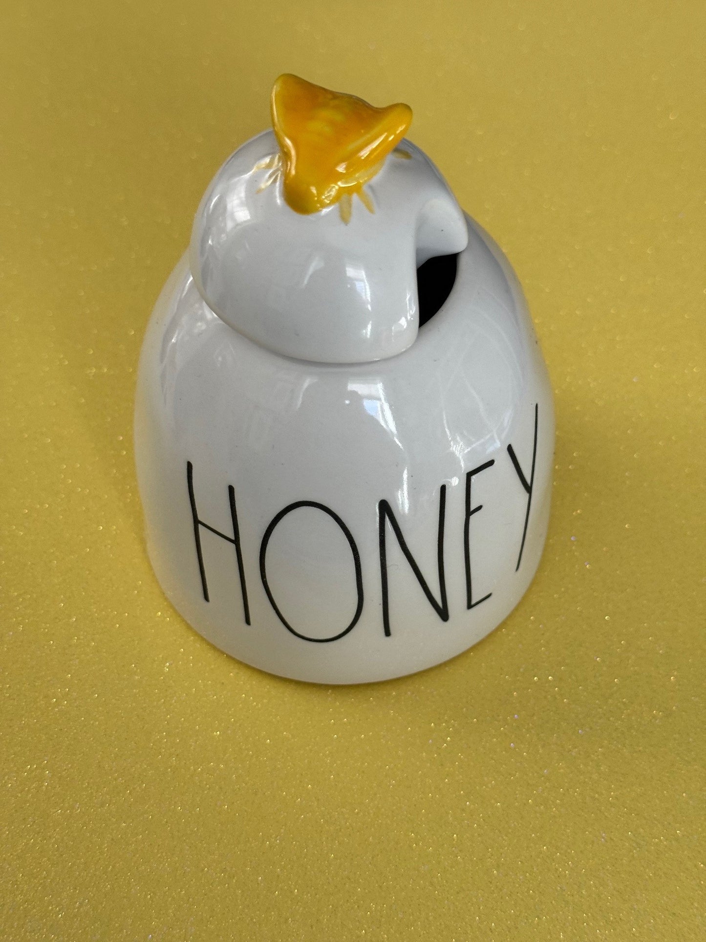 ivory white jar with honey and yellow bee