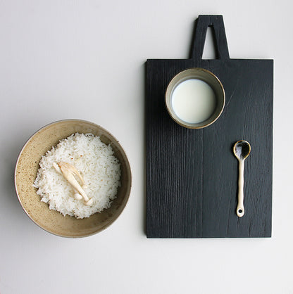 ceramic teaspoon on black cutting board