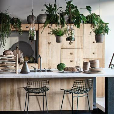 All natural wood kitchen with modern black metal wire bar stools