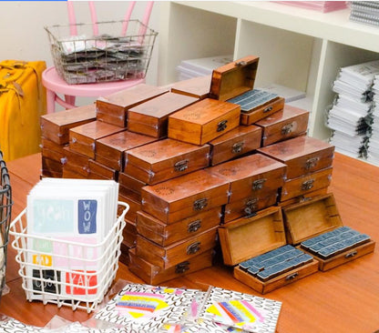 stack of wooden boxes with letter stamps