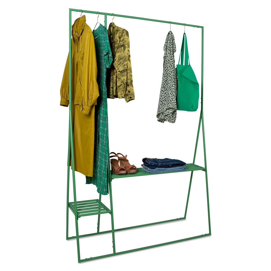 green colored open clothing display rack with dresses and shoes