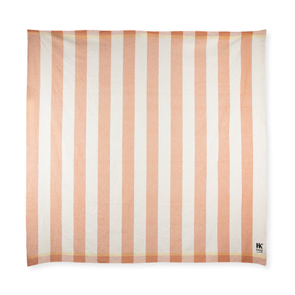 folded peach and cream striped cotton large beach blanket