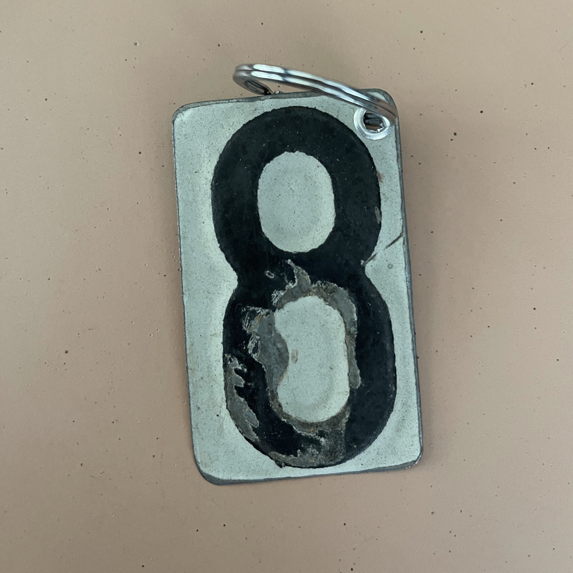 black number 8 keychain from recycled license plate