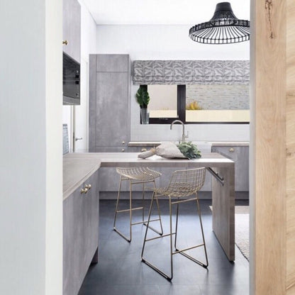 open kitchen with two metal brass wire counter stools under an kitchen island
