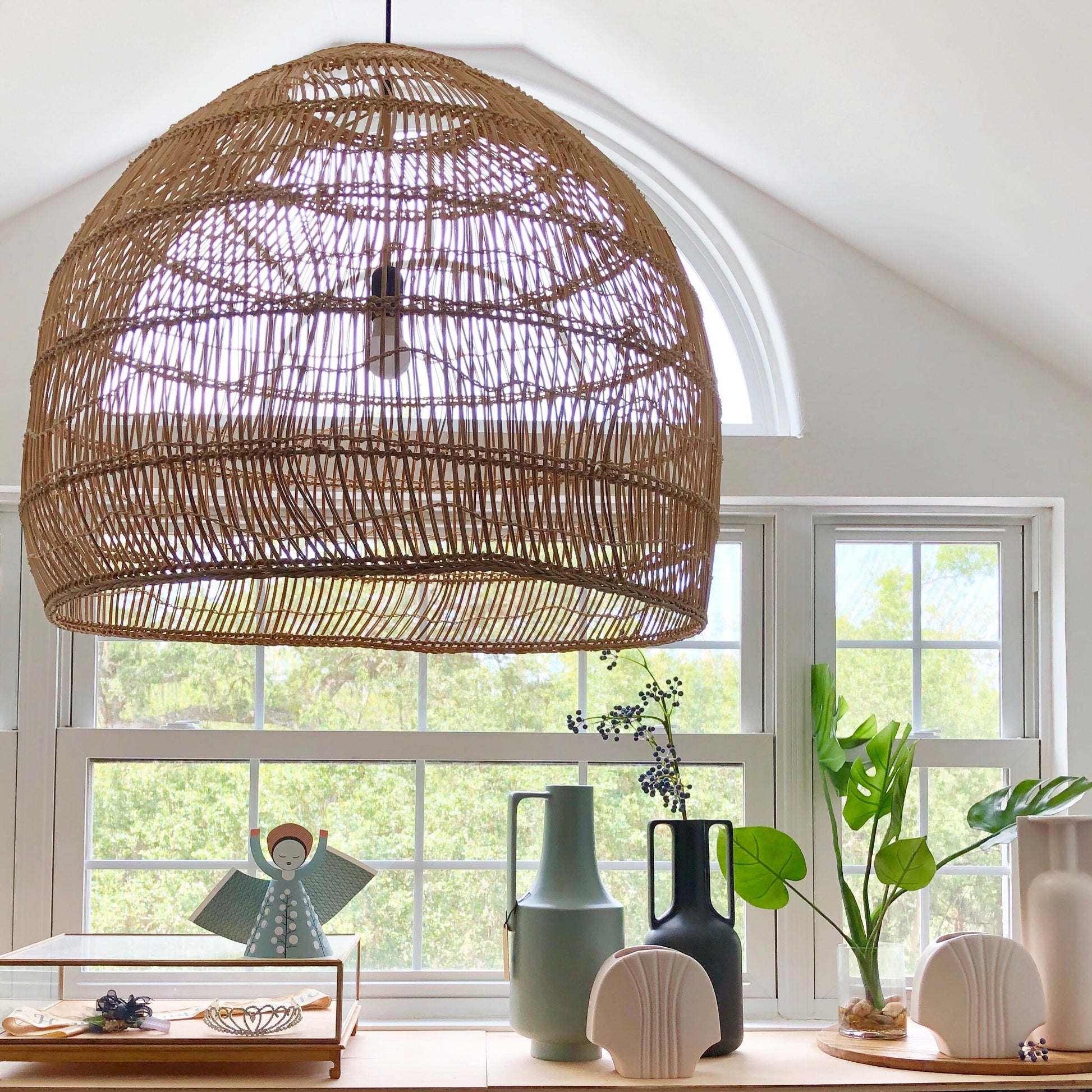 nordic style interior with big basket light and vases 