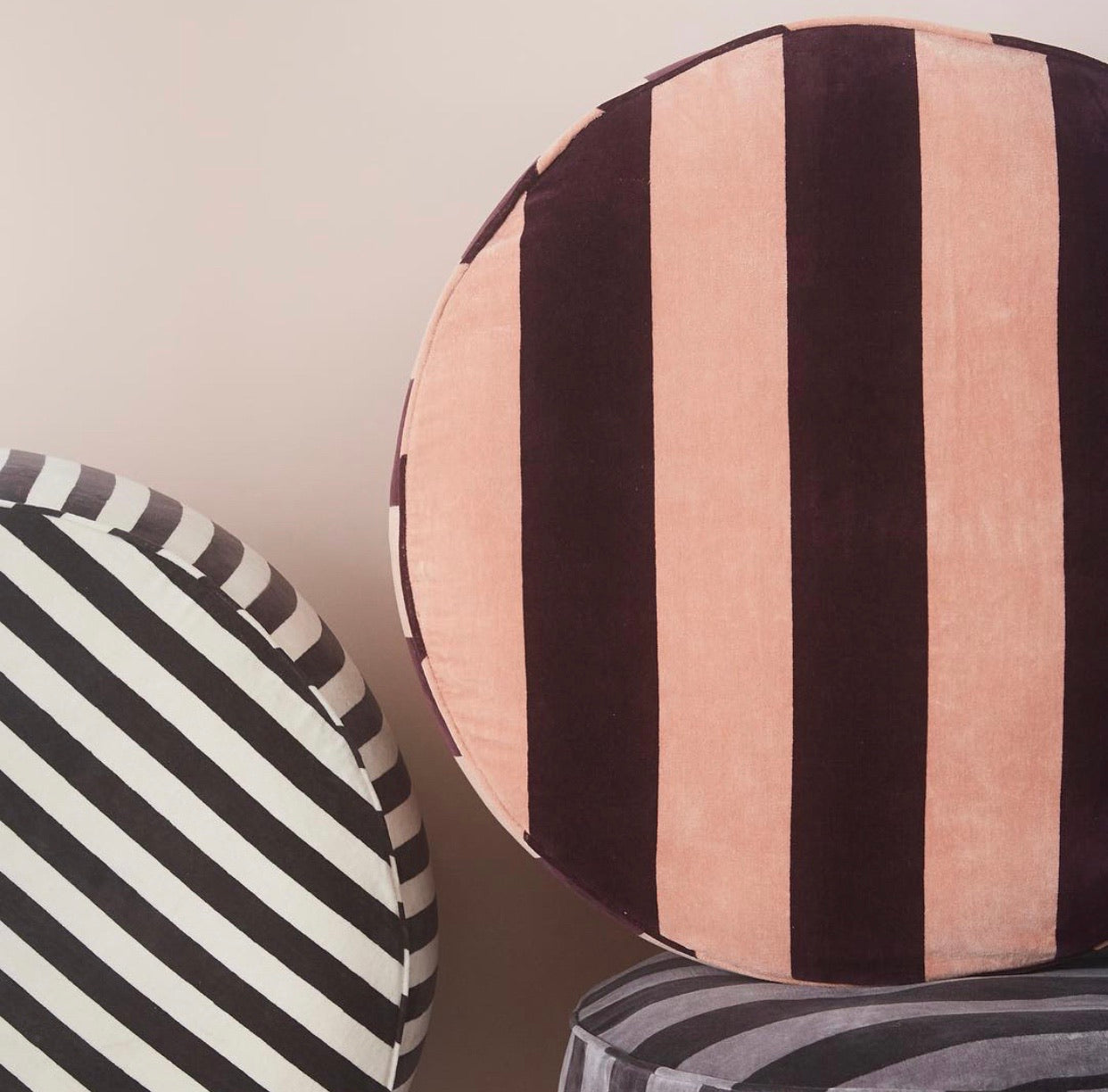 black and white and blush and white striped velvet round poufs