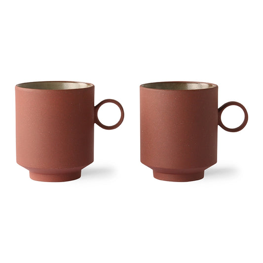 two terracotta colored mugs with ear
