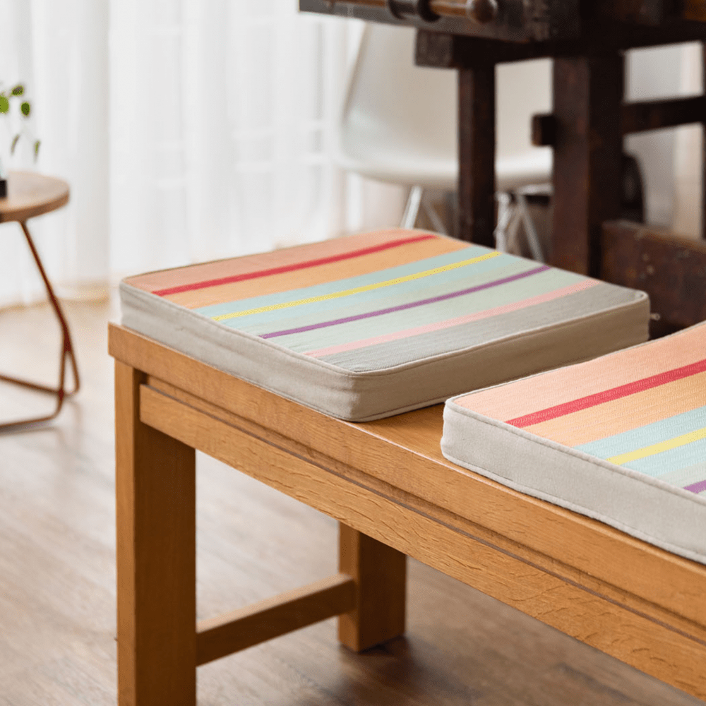 square striped seating cushion on wooden bench