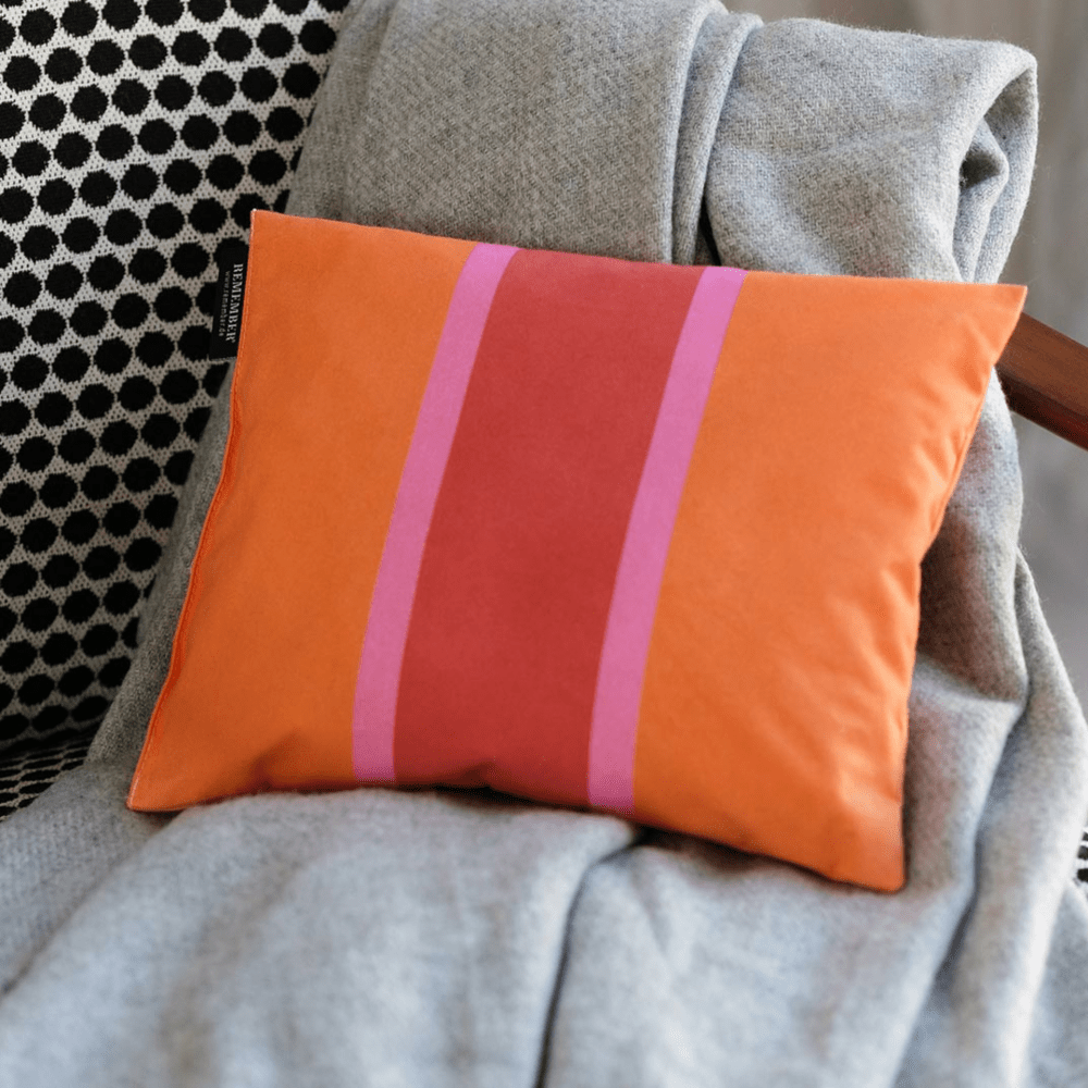 orange pink and red accent pillow filled with swiss stone pine