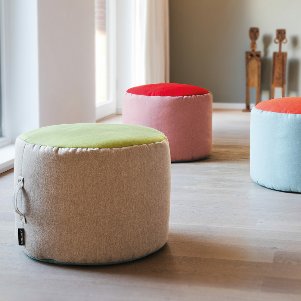 tricolor pouf in beige, green and blue in room