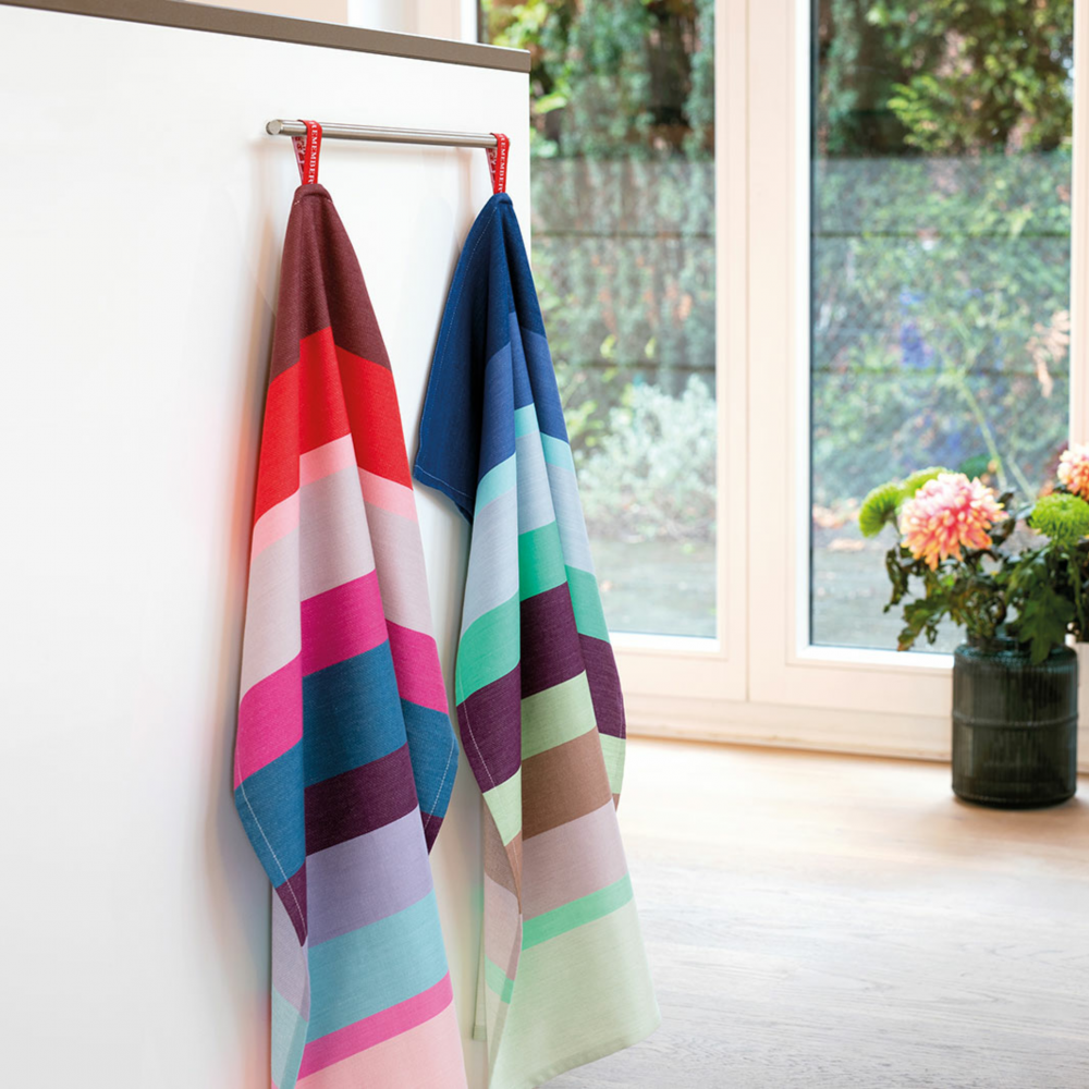 two striped kitchen towels made of colorful cotton hanging in a kitchen