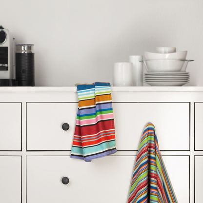 two striped, colorful kitchen towels with big and small stripes displayed on a kitchen counter top