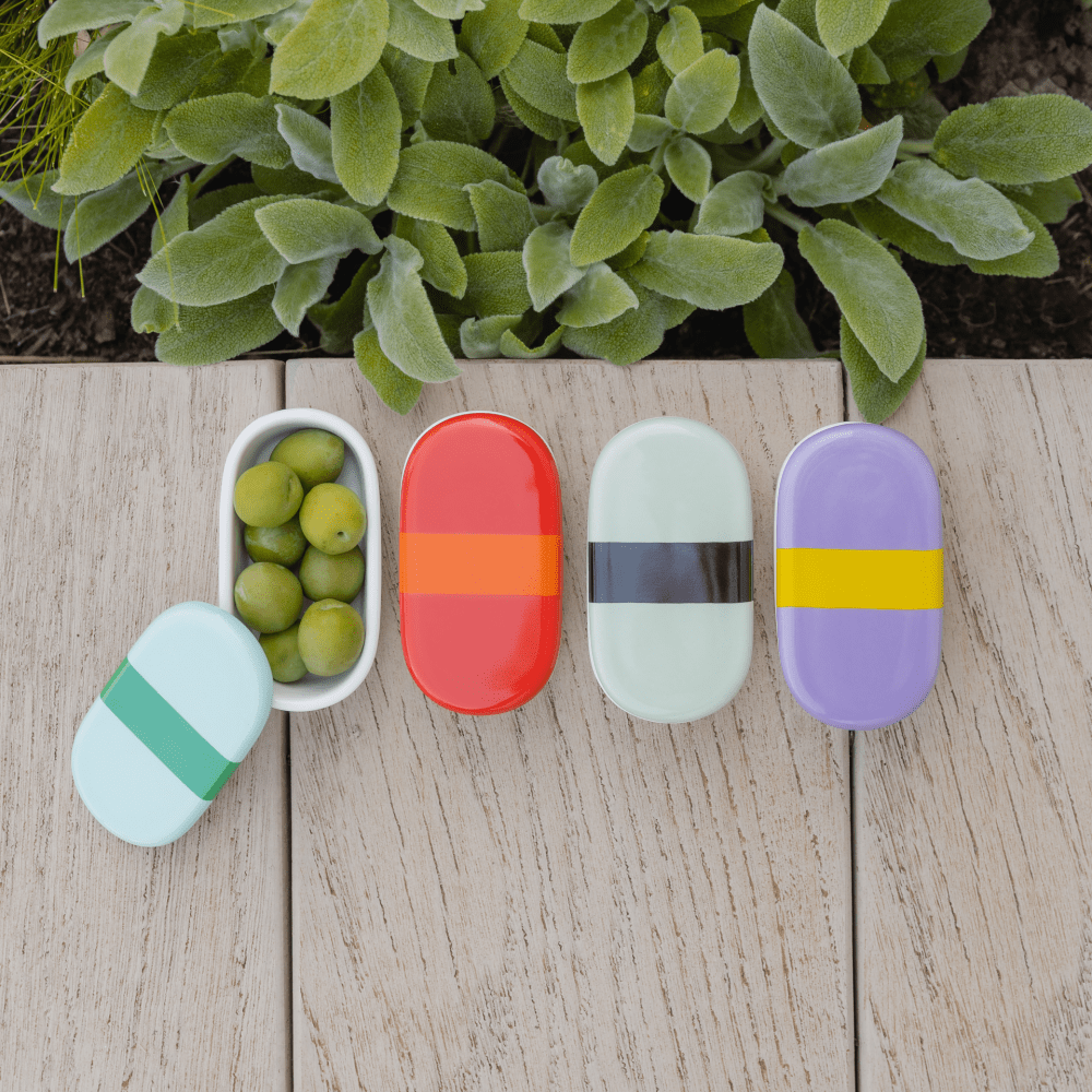 4 porcelain oval boxes with blue lilac green and red  lids with black stripe with olives
