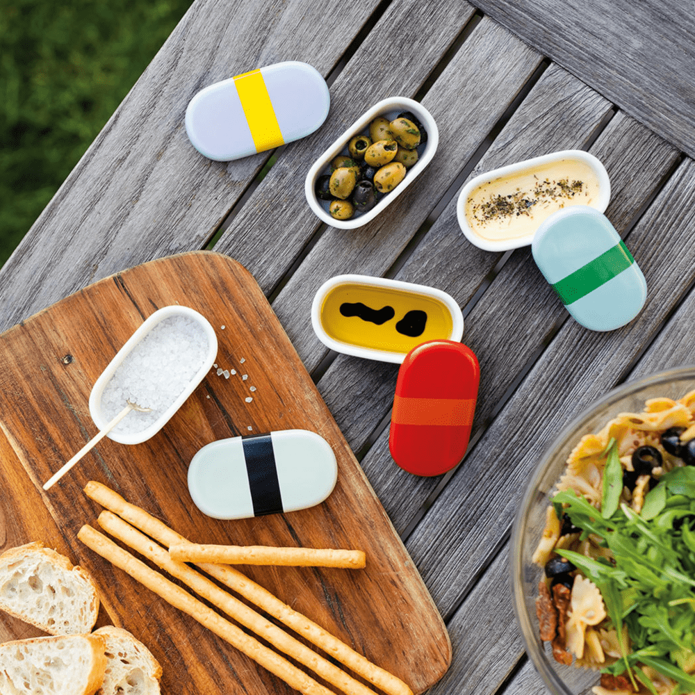 4 porcelain oval boxes with blue lilac green and red  lids with black stripe filled with condiments