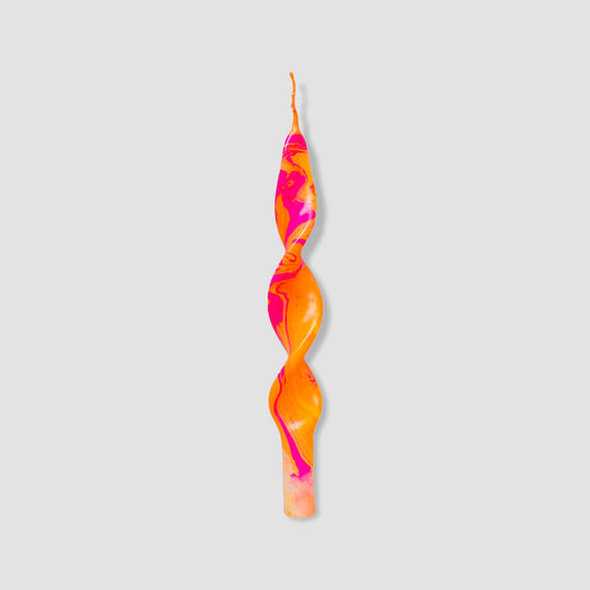 twisted candle with a marble effect in orange and pink