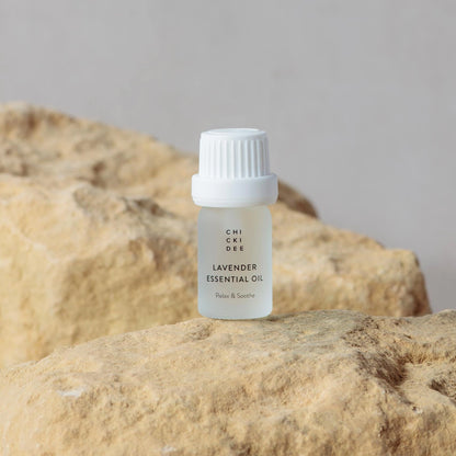 5ml glass bottle with essential lavender oil on a rock