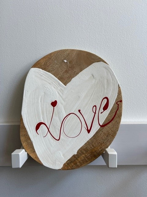 white textured hart with red love signage on a mango wood plate