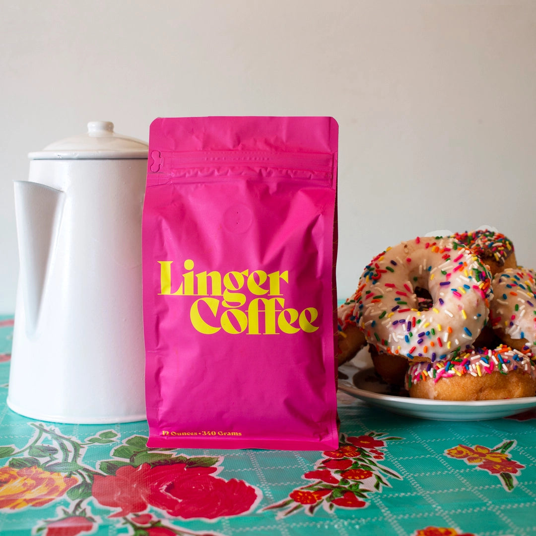 pink bag with yellow letters peppermint mocha coffee with donuts and a coffee pot