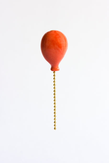 coral colored handmade porcelain balloon pin