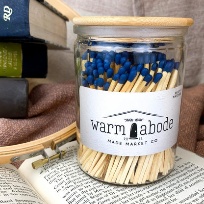safety matches with blue tip in glass vessel with wooden lid